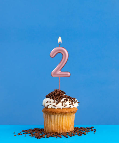 istock Birthday candle with cupcake on blue background - Number 2 2013833062