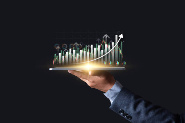 istock Interest rate and dividend concept, Investor hold tablet with glowing graph on virtual screen symbol of invest return profit, return on stocks and mutual funds, long term investment for retirement. 2013840756