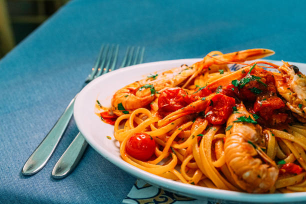 Pasta with Gamberoni / Prawns, Shrimp, and Roasted Tomatoes Pasta with Gamberoni / Prawns, Shrimp, and Roasted Tomatoes in Amalfi, Italy - a Refreshing Summer Dish for Dinner amalfi food stock pictures, royalty-free photos & images