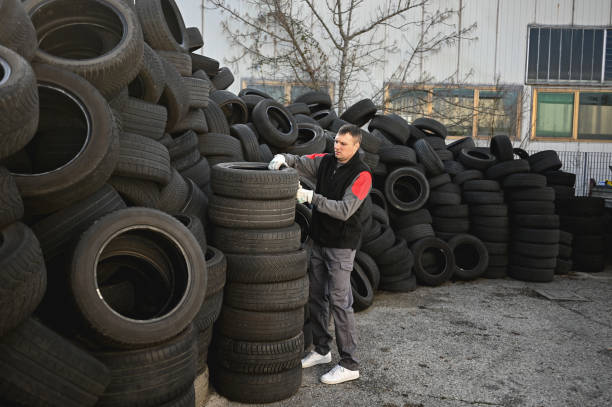 istock man working on reselling car tires for recycling. 2013853713