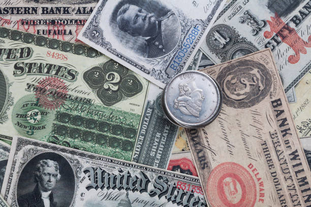 istock Old west period US banknotes and silver certificates with silver dollar coins 2013866566
