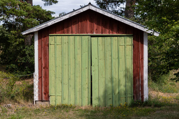 istock A red storage shed with green doors 2013922105