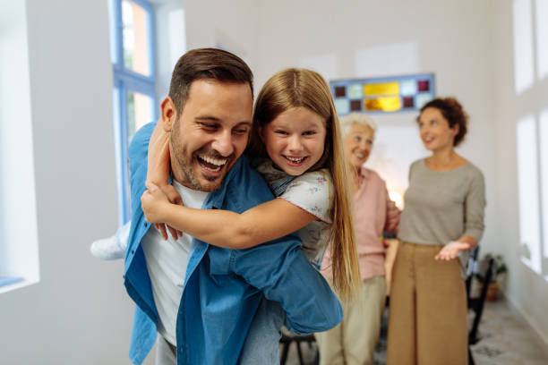 istock Father back carrying his daughter and smiling 2013932129