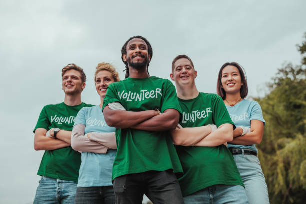 istock Five volunteers in uniforms standing in formation and smiling for the camera 2013963450