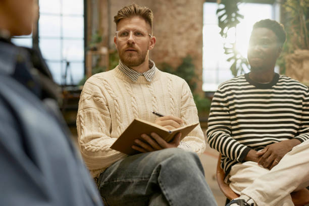 istock Psychologist listening to people in support group 2013972799