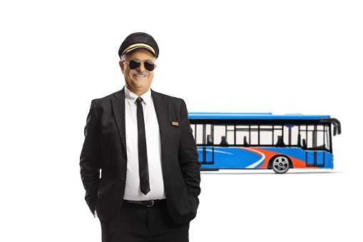 Professional mature chauffeur posing in front of a city bus isolated on white background