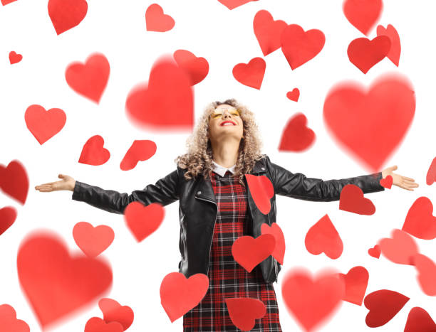 istock Red hearts falling above a young woman in a leather jacket 2013975034