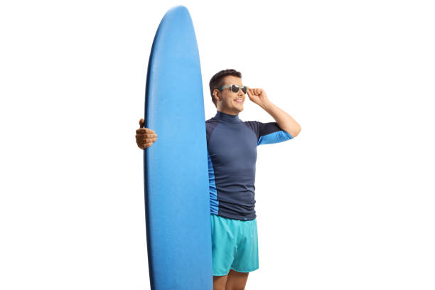 istock Young man with sunglasses and a surfing board 2013975040