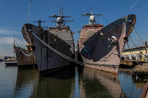 Several retired Ticonderoga-class guided missile cruisers sit at anchor at the NAVSEA Inactive Ships Maintenance Facility at the Philadelphia Navy Yard.