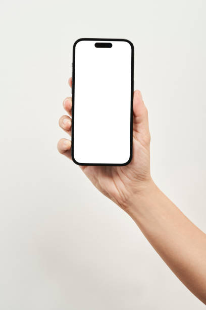 Hand Holding Apple iPhone 14 Pro Istanbul, Turkey - September 15 2023: Someone hand holding new iPhone 14 pro mobile phone over white background. iphone stock pictures, royalty-free photos & images