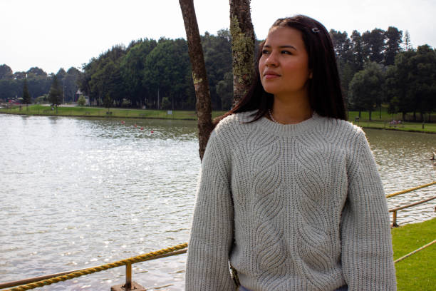 istock Beautiful young woman posing next to a lake 2014068240