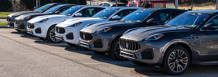 Wexford, Pennsylvania, USA February 4, 2024 A line of new Maserati vehicles for sale at a dealership on a sunny winter day