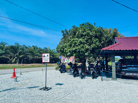 Jeram, Selangor, Malaysia- Feb 11, 2024: Typical motorcycle parking space at Warong Estet Cafe in Jeram, Selangor, Malaysia.