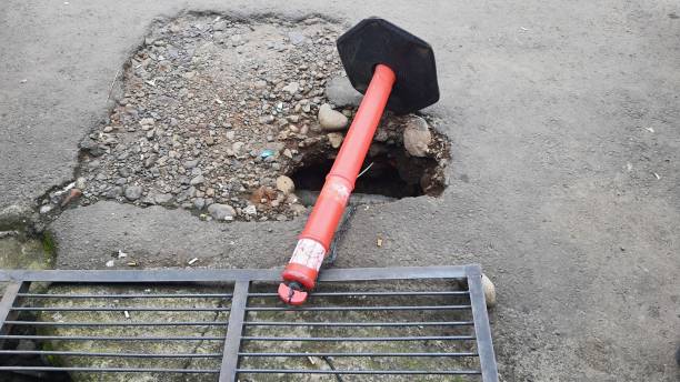 istock Pit hole on the road and marked with orange pole after flood 2014171728