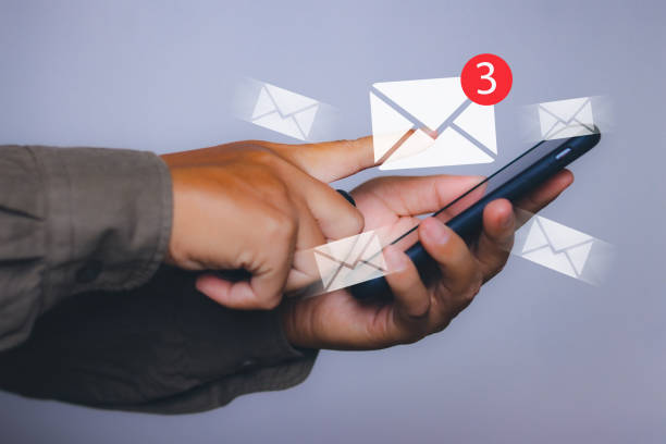 istock man with new email notification for business e-mail communication by smartphone 2014181884