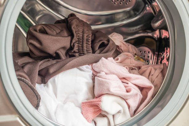 Washing machine loaded with clothes close up