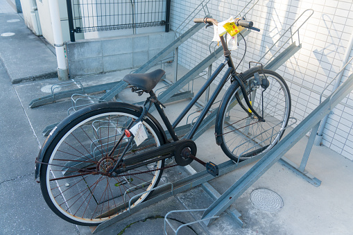 Abandoned bicycle with warning for removal