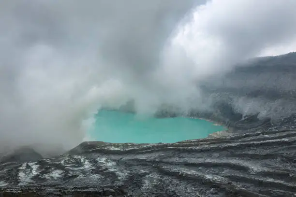 Scenic volcanic landscape and  Ijen volcano crater acidic lake in Java island