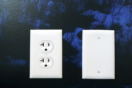 close up on the outlet on painted wall