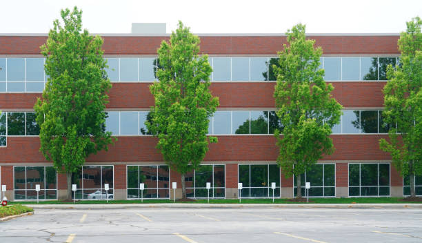 istock facade view of office building with green trees in front 2014267707