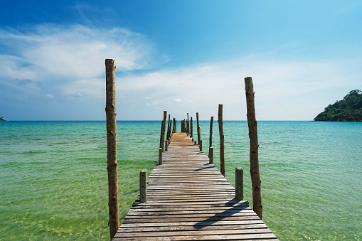 The wooden bridge in the sea at Koh Kood is a tropical island with emerald green water and beautiful beaches, in Koh Kood, Trat, Thailand.