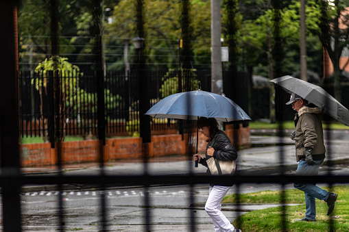 Bogota . Colombia 6 de Febrero  2024: Woman and man with umbrella, rain.