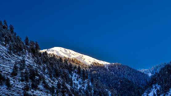 sunrise over the mountains covered with fresh snow. Snow landscape background.