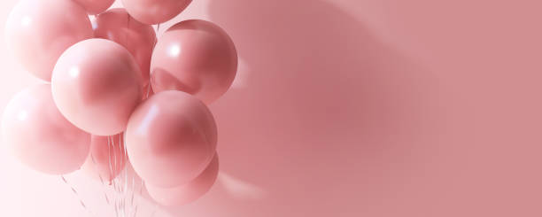 istock Floating matte pink balloons in sunlight, shadow on pink wall 2014458201