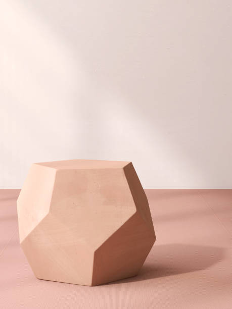 istock Minimal, modern geometric shape brick brown podium table, pentagon side on carpet floor in sunlight on wall 2014465596