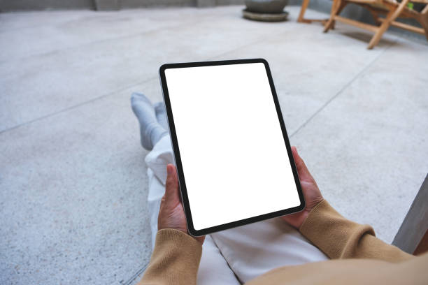 istock Mockup image of a woman holding digital tablet with blank white desktop screen 2014515971