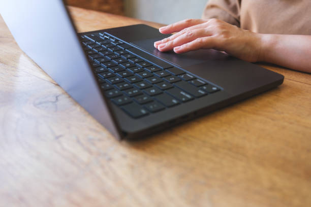 istock Closeup image of a hand working and touching on laptop computer touchpad 2014516012