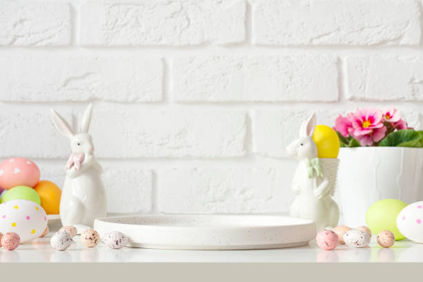 istock Podium plate on table for product display surrounded by easter bunnies, eggs and flowers 2014564517