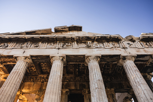 View of the iconic Ancient Agora of Athens. Temple of Hephaestus, in the Ancient Agora of Athens (Greece) at sunset. Concept of history and culture of old classical Athens.