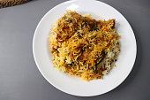 Homemade chicken Biryani or Pulao. Garnished with fried onion and chopped coriander. Biryani is a famous Spicy nonvegetarian dish of India. poultry meat cooked along with Basmati rice and spices.
