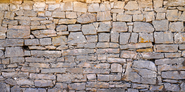Old ancient stone wall background facade horizontal stones wallpaper