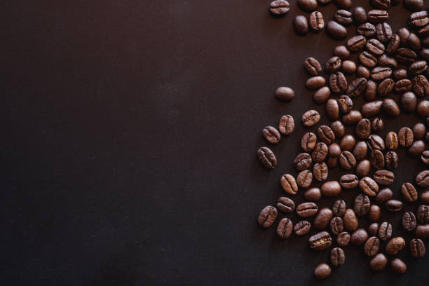 istock close up of roasted coffee beans on black background with copy space 2014666036