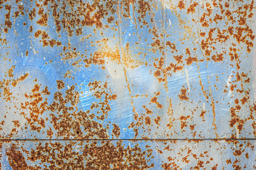Blue background of old metal sheet with rust
