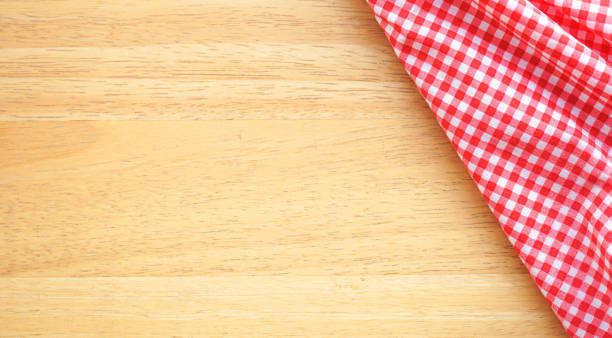 istock Wood table background with crumple pink plaid fabric or tablecloth in the corner 2014682703