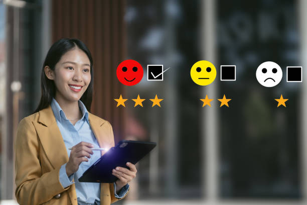 istock Woman holding a digital tablet with checkboxes rating smiley faces excellent for Satisfaction Survey, Happy Client Customer Experience concept. 2014701835