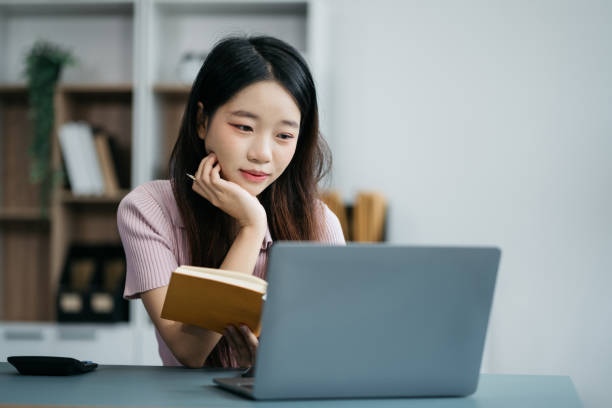 istock Female writes information businessman working on laptop computer writing business plan while sitting in office. 2014701841