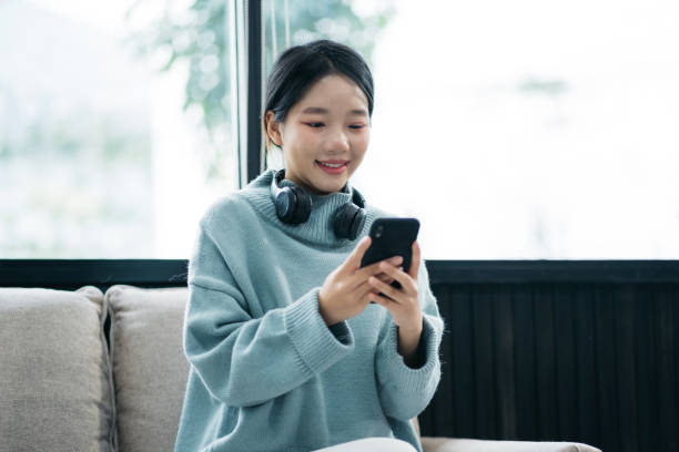 istock Smiling woman in headphones taking notes, motivated interested student studying online, using tablet, watching webinar training or listening to lecture, remote education concept. 2014701889