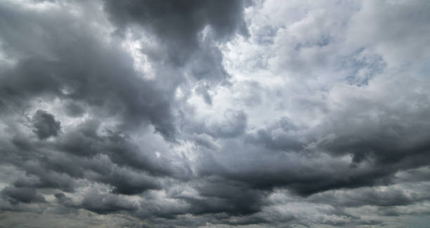 dark sky with stormy clouds. dramatic sky ,dark clouds before a thunder-storm. - ciel-orageux photos et images de collection