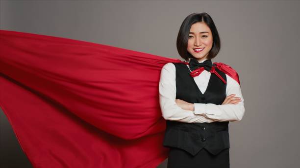 istock Asian receptionist posing with red superhero cape on camera 2014717790