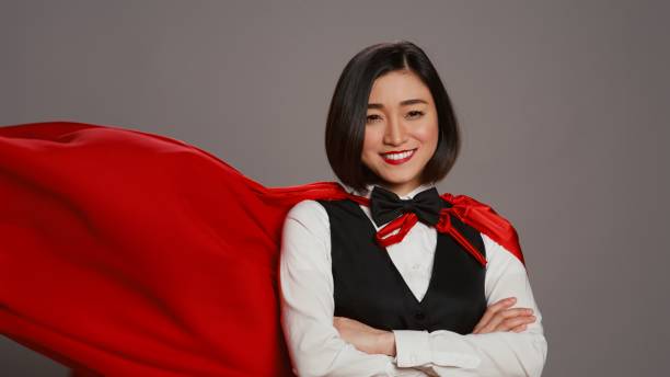 istock Asian receptionist posing with red superhero cape on camera 2014721462