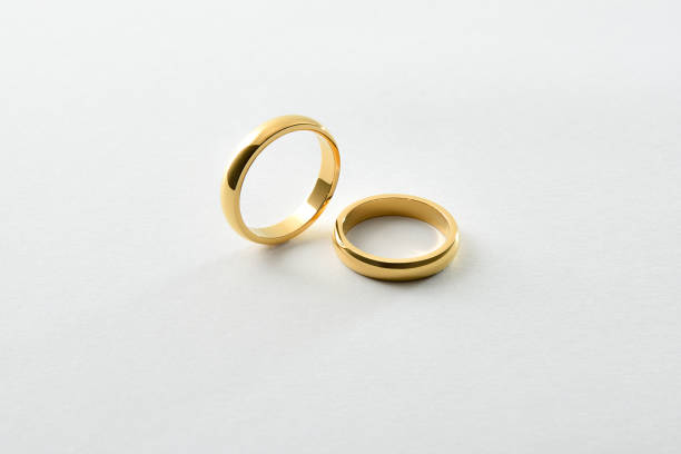 istock Engagement gold rings standing and lying down isolated over white 2014725695