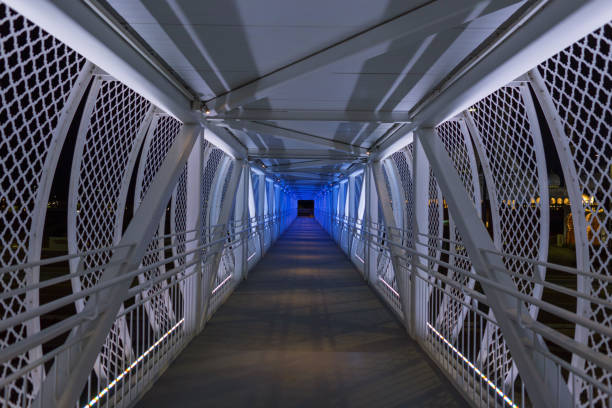 istock Direct walking metal lights bridge in Abu Dhabi at night. Path and solution 2014731064