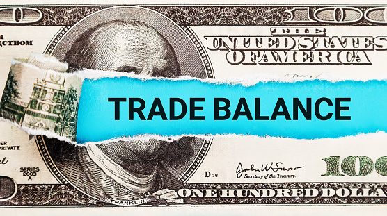 Trade Balance. The word Trade Balance in the background of the US dollar. International Trade and Economic Equilibrium Concept.