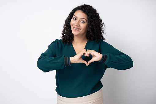 Portrait of young businesswoman with curly hairstyle wear trendy smart casual outfit isolated on white background