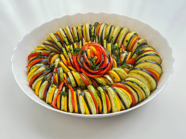istock Baking mold with zucchini, tomatoes, eggplant and herbs, sliced and beautifully arranged. 2014785209