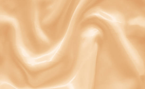 istock golden or yellow satin fabric background 2014786280